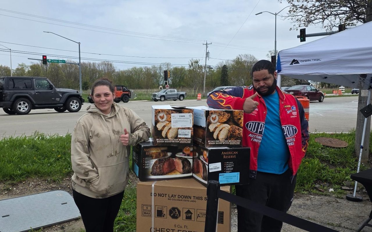 Two customers with their boxed order and freezer