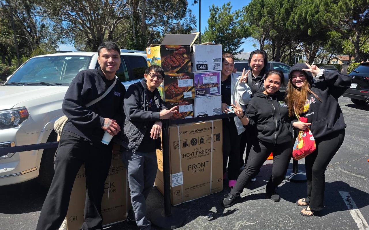 A group of customers with their steak boxes and a new freezer