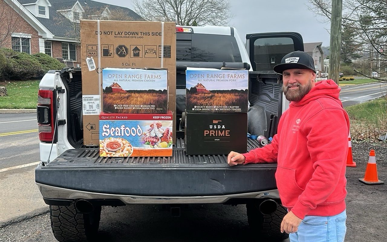 A customer loading a new chest freezer and steak boxes into his pickup